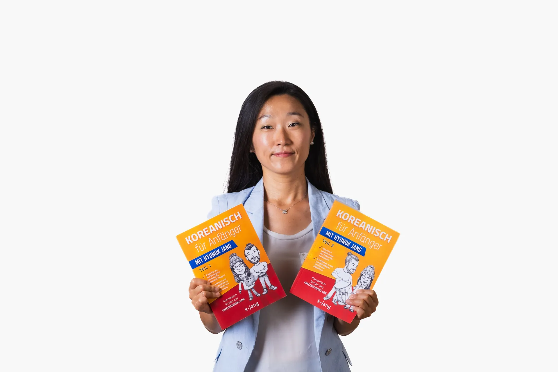 Hyunok holding up two Korean course books
